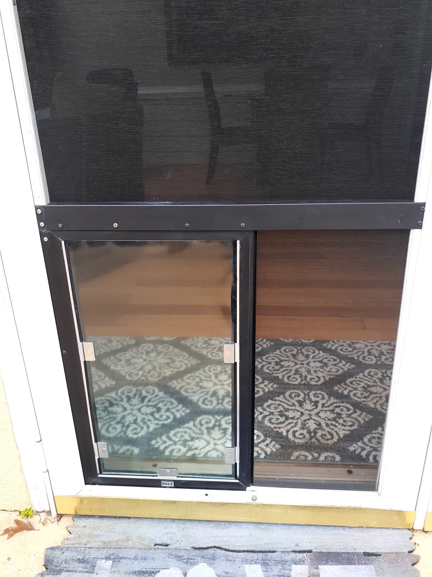 A pet door installed in a decorative glass door
