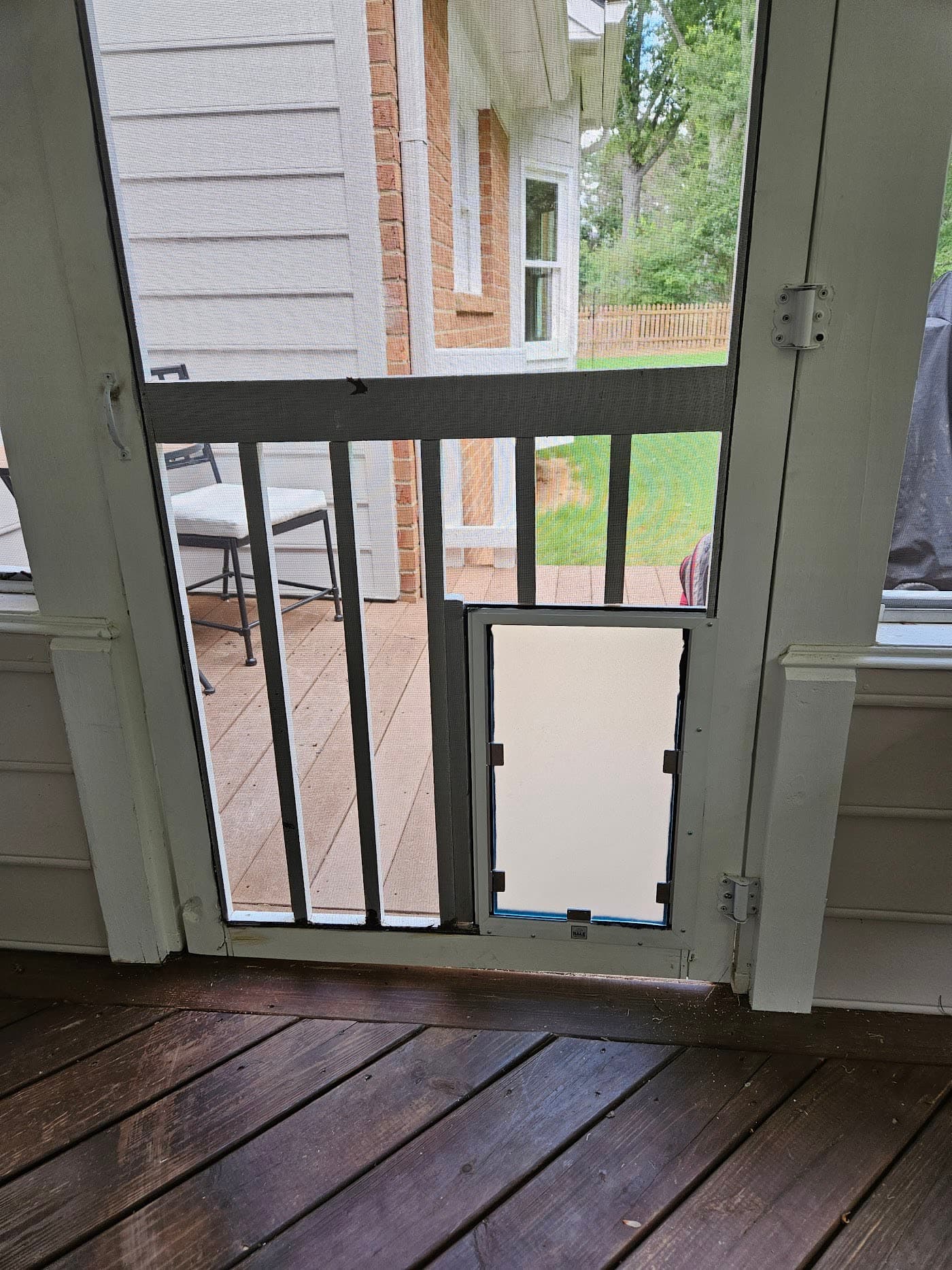 A pet door giving access to a screened porch