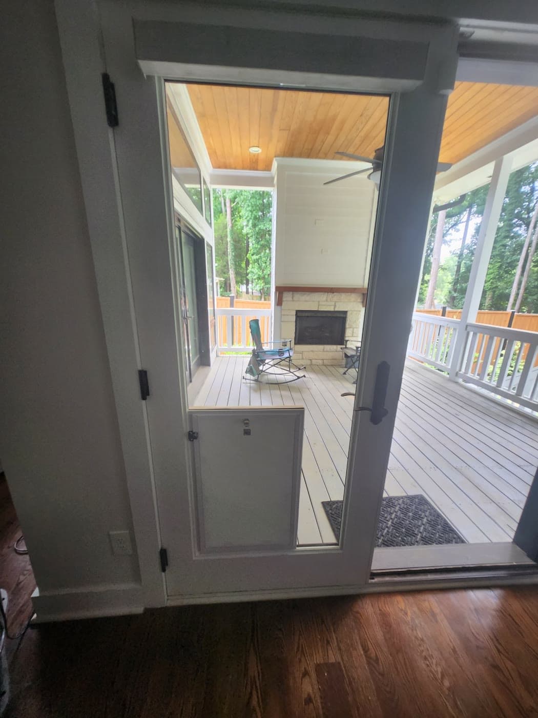 A pet door installed in a glass French patio door opening onto a covered porch in a Georgia home